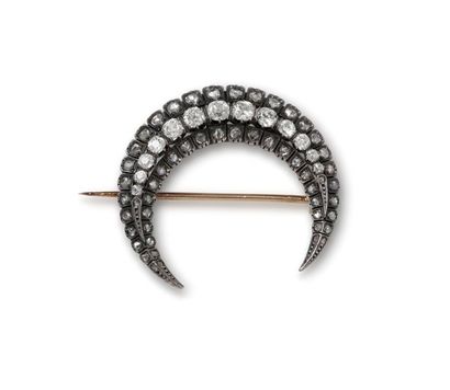 null Brooch in 18K (750/1000) pink gold and silver (800/1000) forming a crescent...