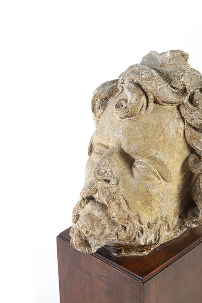 Carved limestone head of a man. Hair elaborated...