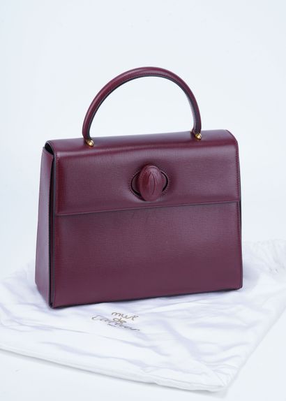 CARTIER Turnlock handbag. Bordeaux leather. Dimensions: 22cm - 28cm - 9cm. Certificate...
