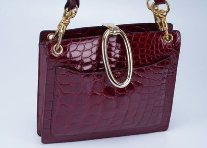 Christian Dior Christian Dior handbag, shiny red crocodile leather and gold metal....