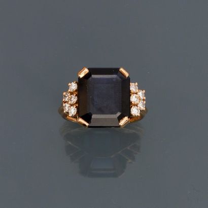 null Yellow gold ring, 750 MM, decorated with an emerald cut blue stone with cut...