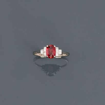 null White gold ring, 750 MM, decorated with an oval ruby weighing about 0.90 carat...