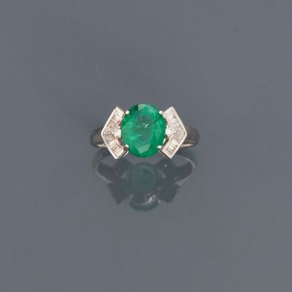 null White gold ring, 750 MM, decorated with an oval emerald weighing 2.46 carats...