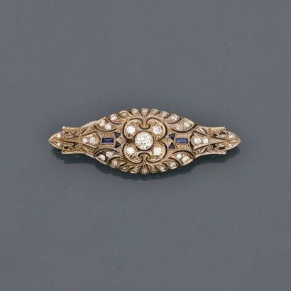 null Brooch in white gold, 750 MM, covered with diamonds and calibrated blue stones,...