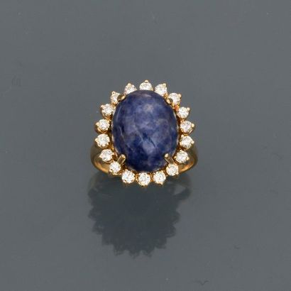 null Yellow gold ring, 750 MM, centred on a lapis lazuli cabochon with diamonds,...