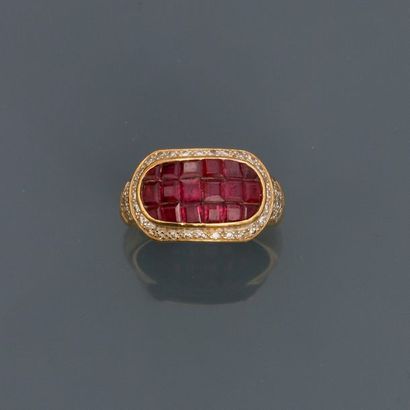 null Yellow gold ring, 750 MM, decorated with invisible set rubies surrounded and...