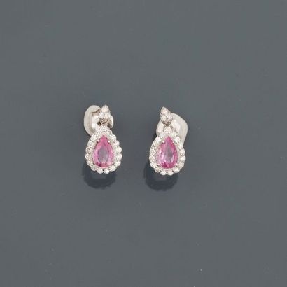 null White gold earrings, 750 MM, each adorned with a pear-shaped pink sapphire carried...