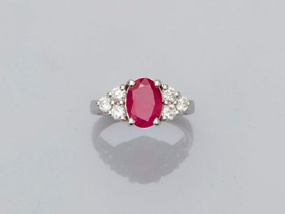 null Ring in white gold, 750 MM, set with an oval ruby weighing 2.25 carats and supported...
