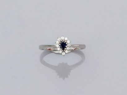 null Small white gold ring, 750 MM, centered on a pear-cut sapphire surrounded by...