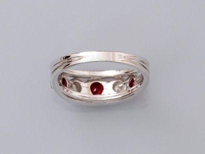 null Ring " ring " in white gold, 750 MM, decorated with three round rubies interspersed...