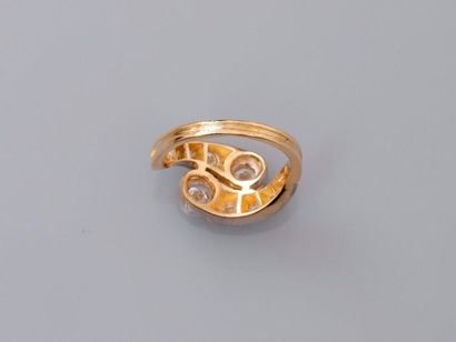 null Two-gold ring, 750 MM, set with two round diamonds in settings carried by two...