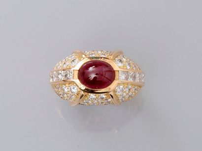 null Yellow gold ring " Boule ", 750 MM, centered of an oval cut ruby cabochon shouldered...
