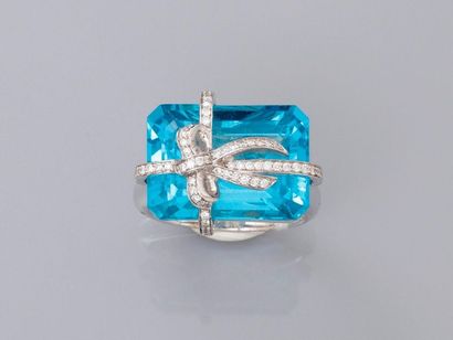 null Ring " Gift " in white gold, 750 MM, decorated with a rectangular blue topaz...