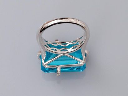null Ring " Gift " in white gold, 750 MM, decorated with a rectangular blue topaz...