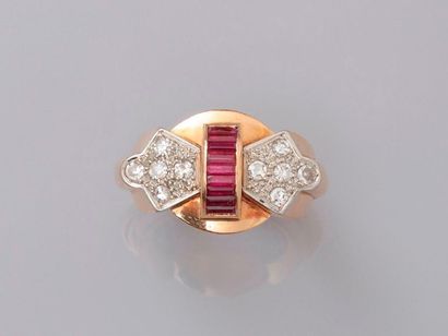 null Ring in pink gold, 750 MM, centered by a line of calibrated red stones shouldered...