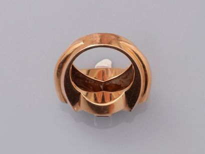 null Ring in pink gold, 750 MM, centered by a line of calibrated red stones shouldered...