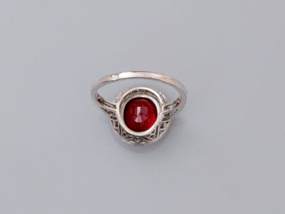 null Thin white gold ring, 750 MM, centered of an oval treated ruby finely surrounded...