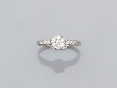 null Solitaire ring in white gold, 750 MM, centered by a flower covered with diamonds...