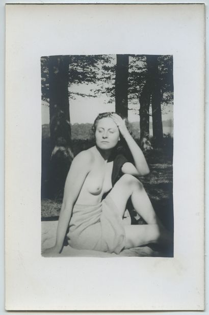 null AMATEUR PHOTOGRAPHER. Young blonde woman stripping in a clearing, late 1930s....