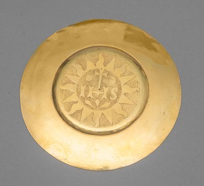 null Paten in gilt engraved with the initials IHS accompanied by the sun and the...