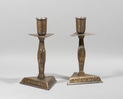 null Rare pair of candlesticks in iron inlaid with gold.

The triangular base receives...