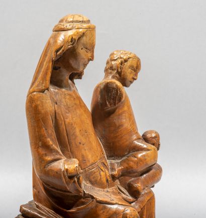 null Virgin and Child in boxwood carved in the round. Seated on a bench, Mary is...