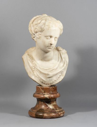 Bust of young woman in marble; on a pedestal

in...
