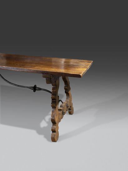 null 
Large community table in walnut resting




on two feet carved with interlacing...