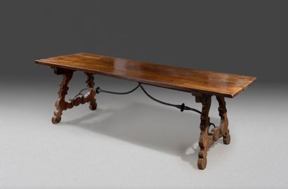 null 
Large community table in walnut resting




on two feet carved with interlacing...
