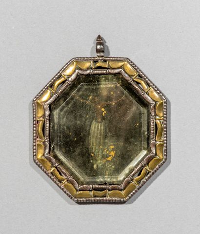 null Octagonal medallion in rock crystal

encircled with iron and brass enclosing

an...