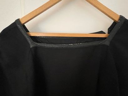 null Courrèges.

Vintage black wool dress with leather trimmed neckline (edge damaged)...