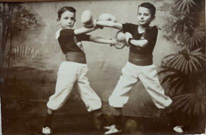 null Advertising sign 

by photographer W.J. Dubois

Young boys doing boxing tricks,...