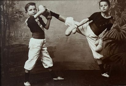 null Advertising sign 

by photographer W.J. Dubois

Young boys doing boxing tricks,...
