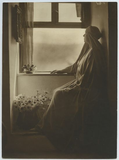 null Woman at the Window. Vintage silver print, 22,7 x 16,6 cm. 2 stamps of the photographer...