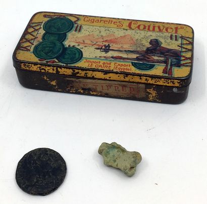 null ANTIQUITY. A bronze coin and a stone phallic amulet. Joint: a tin advertising...