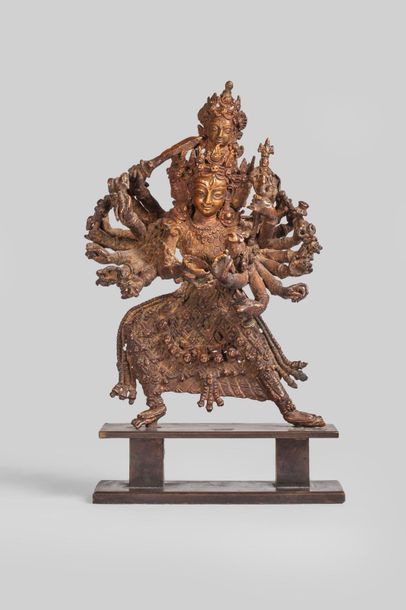 null Durga debout en pratialidasana sous une forme à 16 bras et 4 têtes tenant les...