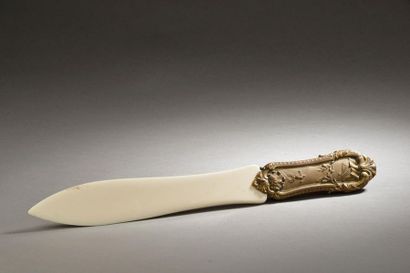  Edmond Furay RAMBAUD (1861-?). Coupe-papier en ivoire, le manche en bronze à décor...