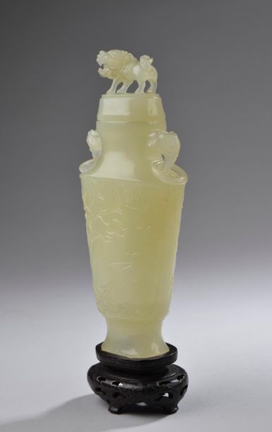 null CHINE.
Vase couvert en jade blanc céladonné à décor incisé de phœnix parmi les...