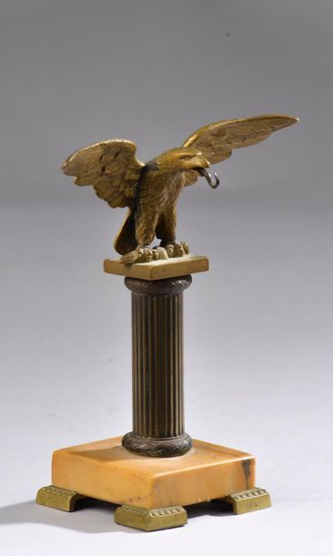 null Porte-montre en régule à patine dorée figurant un aigle aux ailes déployées...