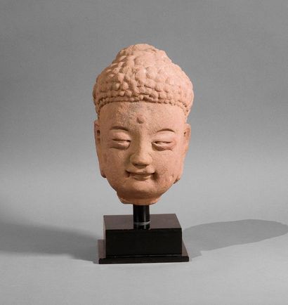 null **Tête de Bouddha en grès rose, le front orné de l'urna, le visage esquissant...