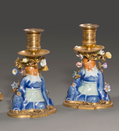 null Pair of small polychrome porcelain torches decorated with seated magots and...