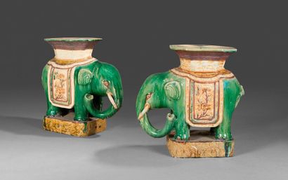 null WELL HOA. Pair of partially glazed stoneware elephants with green background...