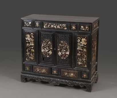 null Blackened wood cabinet opening with two carved doors decorated with two medallions...