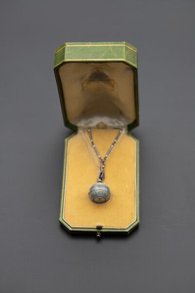 null Lacloche Frères. Circa 1920. Watch known as Boule de Genève and its chain composed...