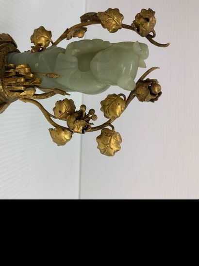 null Sujet en jade celadon monté sur une base en bronze rehaussée de vignes et roseaux....