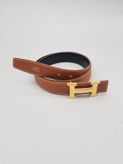 null HERMÈS, Paris

Brown grained leather belt lined with smooth black leather. Gold...