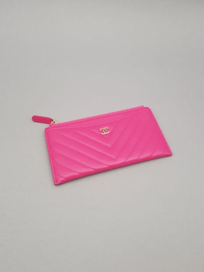 
CHANEL

Pink lambskin leather zippered wallet...