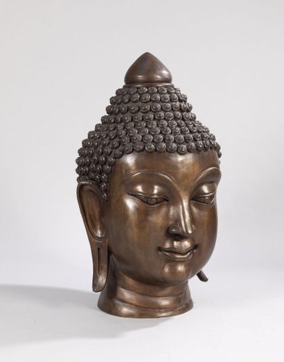 null Sculpture in bronze with a shaded golden-brown patina showing a large Buddha...