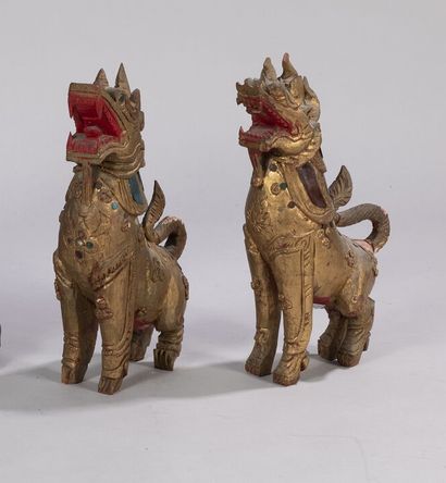 null Pair of carved and gilded wooden subjects partially lacquered with red cinnabar...