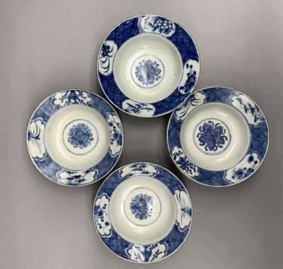 null 
Set of four circular porcelain bowls with silver rim. Decorated in blue and...
